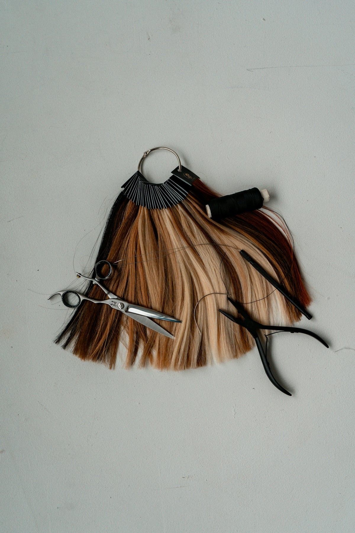 a pair of scissors sitting on top of a piece of hair
